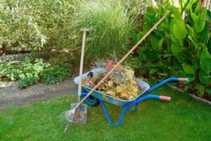 2 7cbdf8808bc2 - Wheaton Lawns Wheelbarrow full of debris with shovel and rake in front of a garden in Fremont, NB